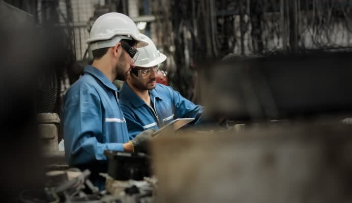 Employees wearing hard hats in a factory