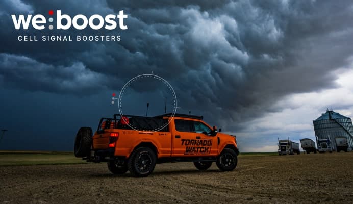 Pickup truck on a farm with clouds in the background